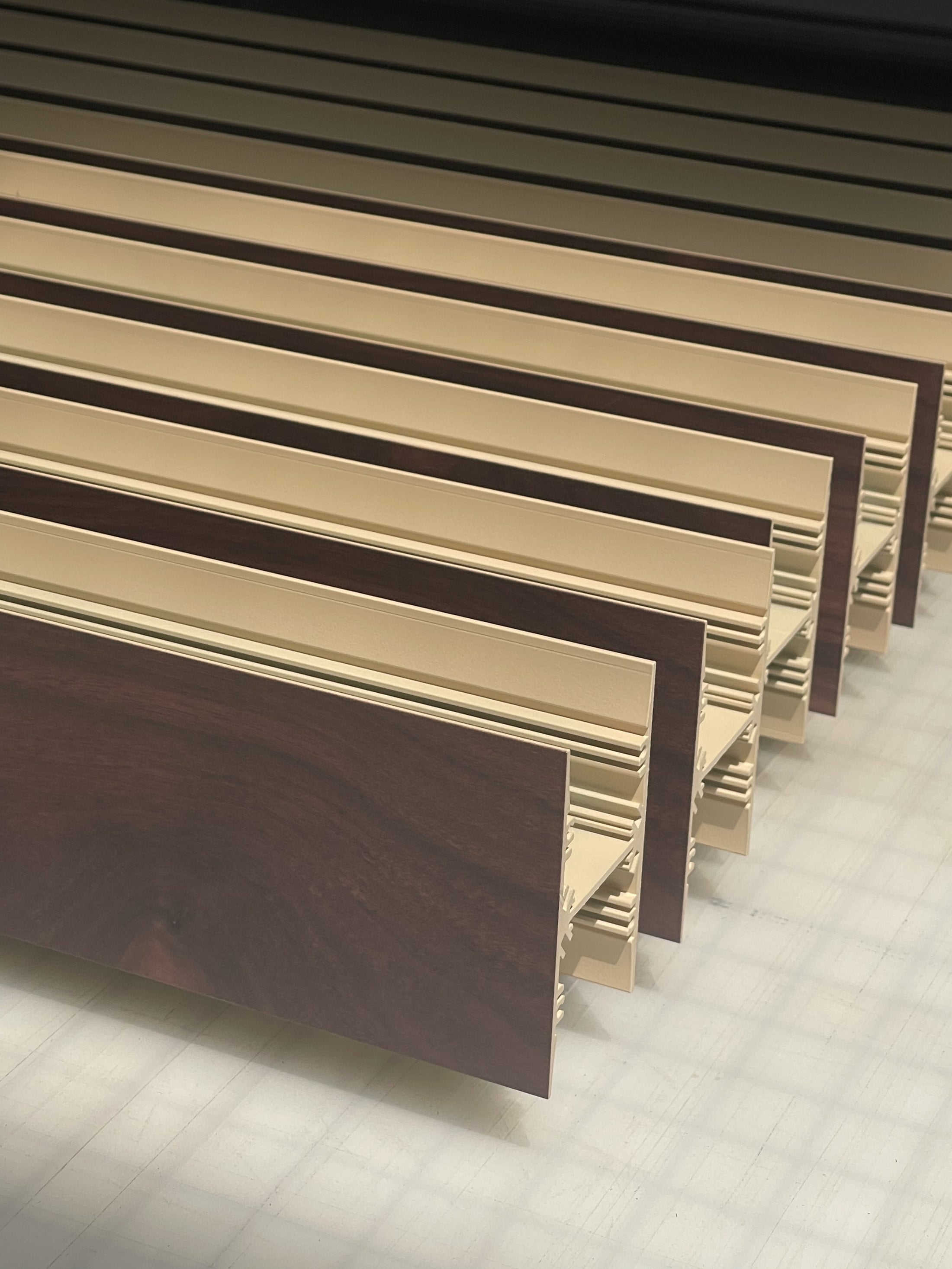 Linear pendant luminaire with a walnut finish printed directly onto the aluminum housing