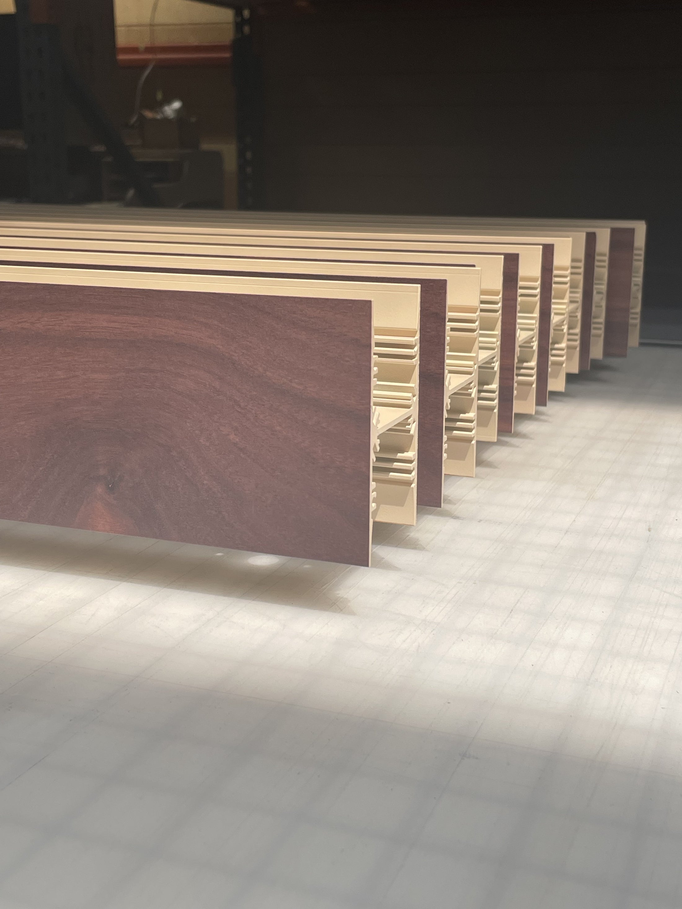 A completed run of printed aluminum extrusions standing on the shop floor